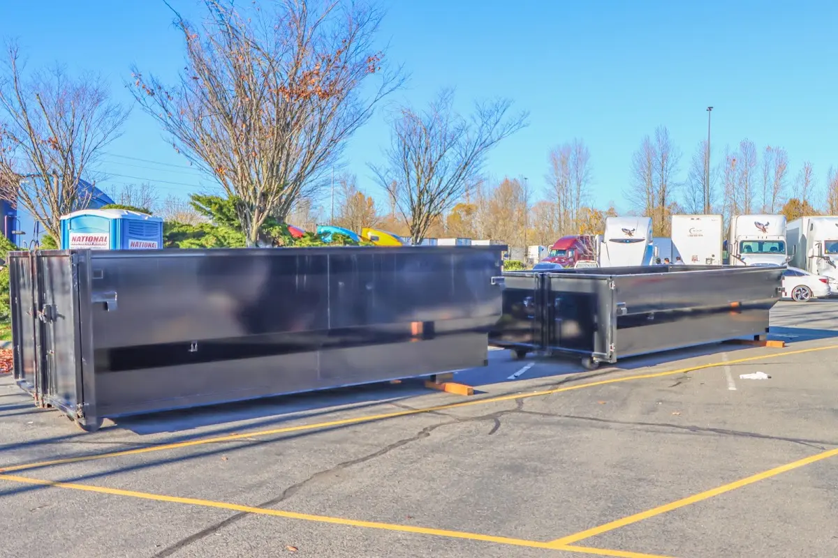 Professional dumpster rental service with roll-off container on residential driveway in Purcell